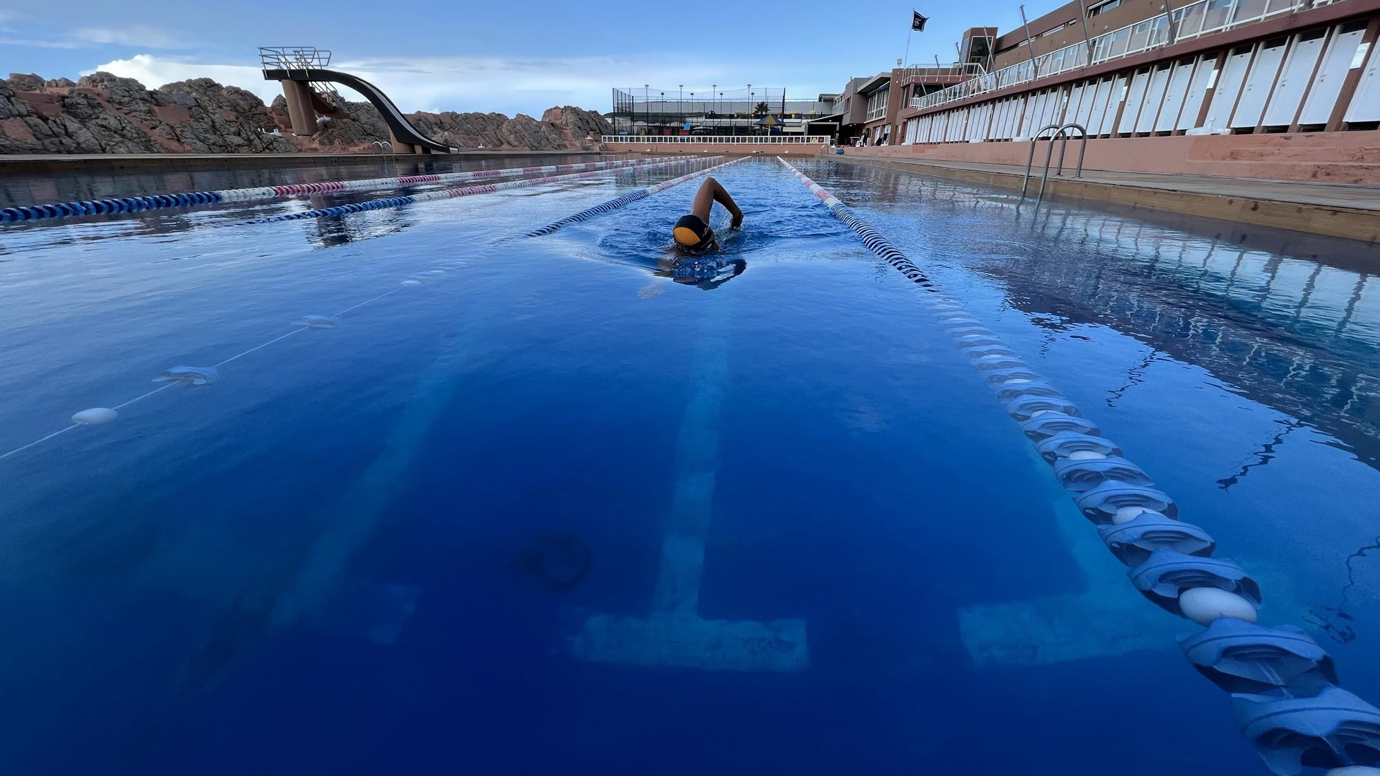 A swimmer doing freestyle in a lane of the pool